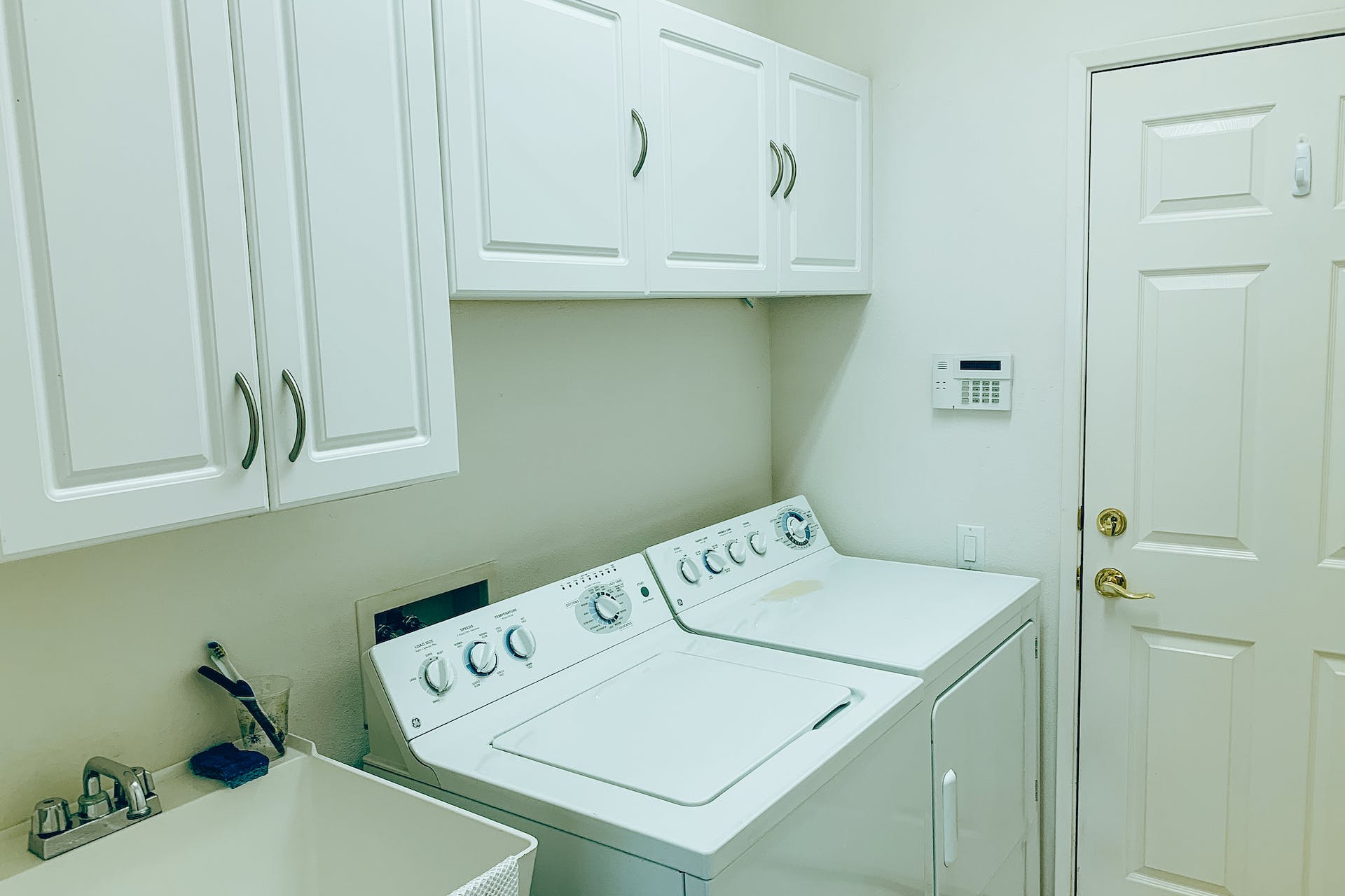 Laundry room with a top loading washing machine