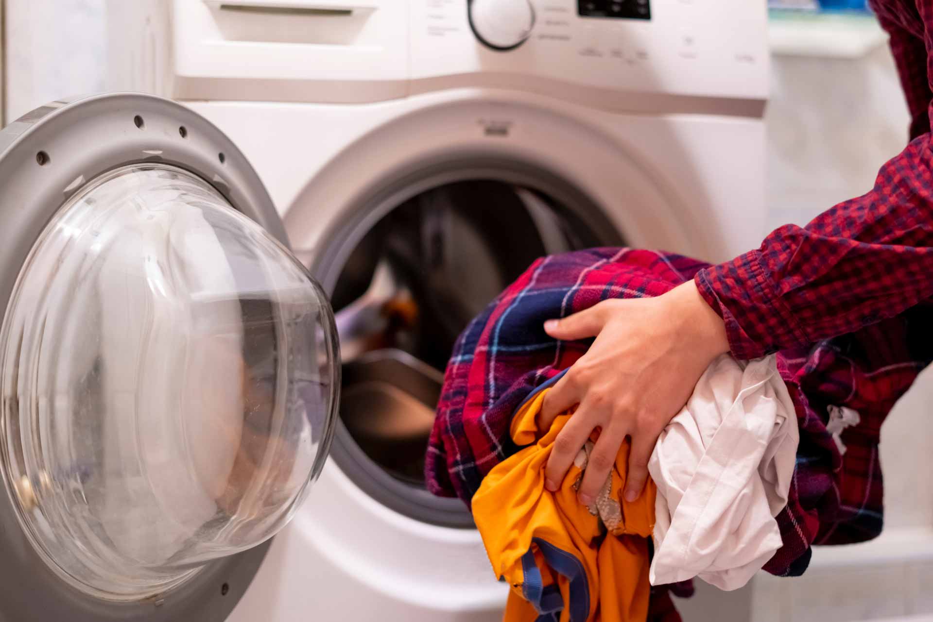 Man loading dryer with clothes